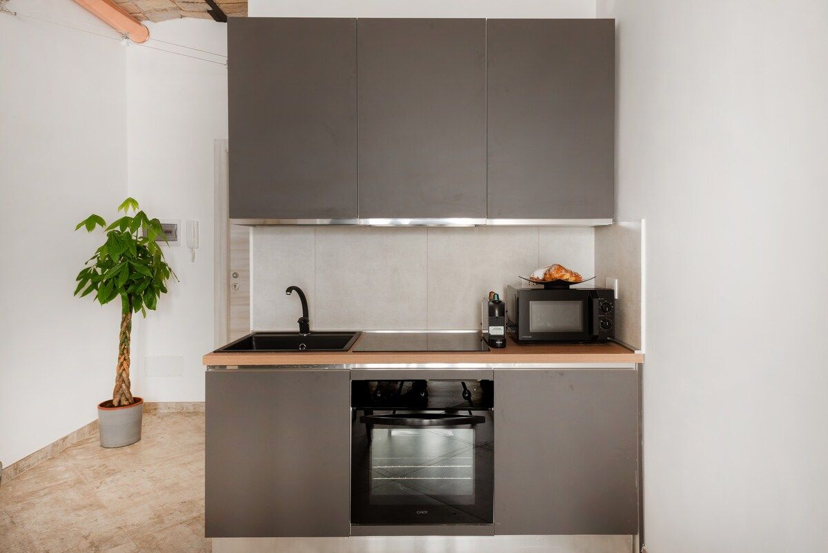 Kitchen with oven and coffee machine