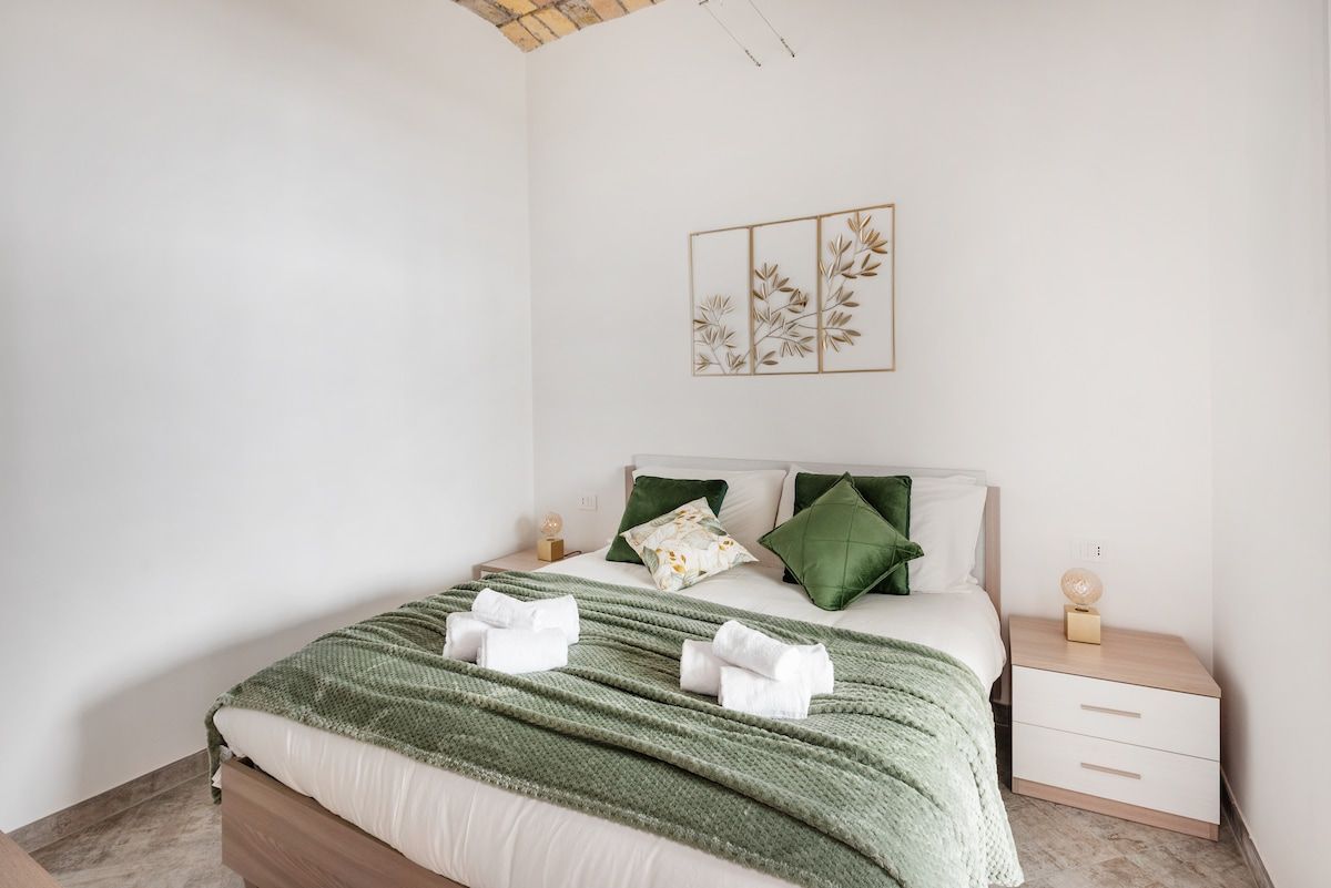 Double bedroom with sage green linen