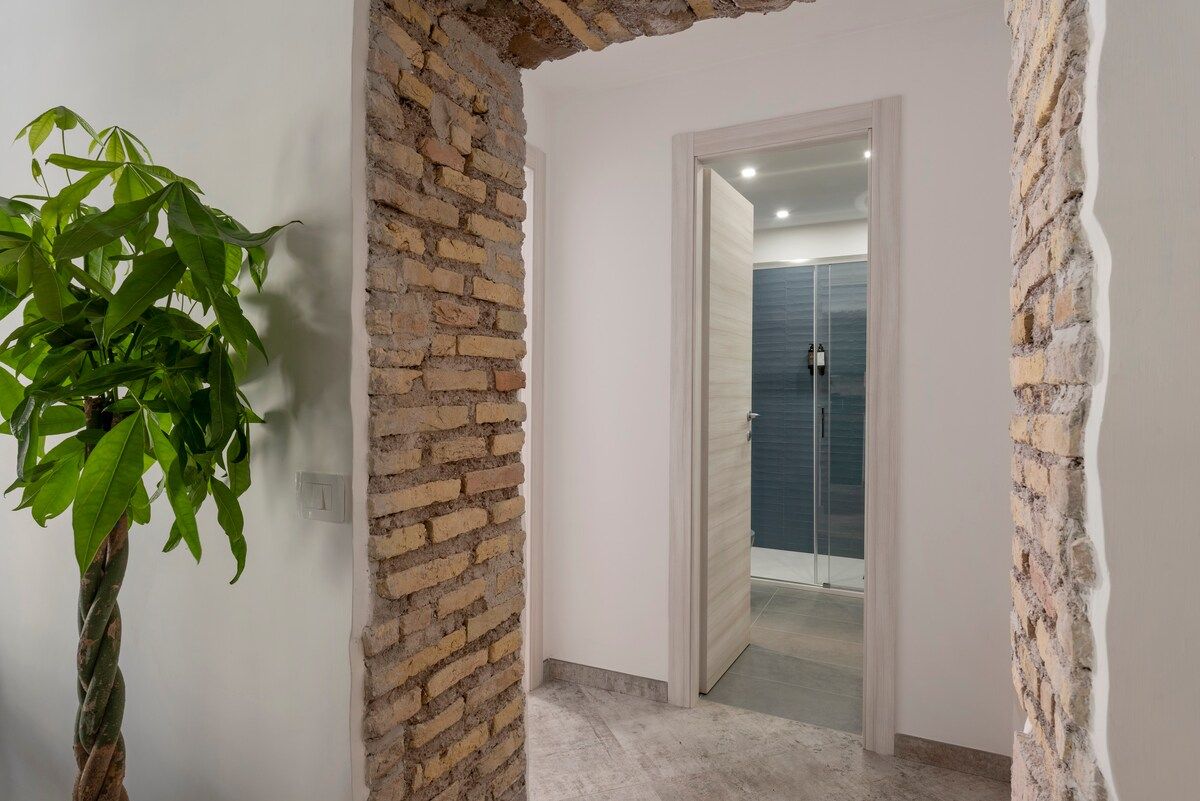 Hallway with original brick wall